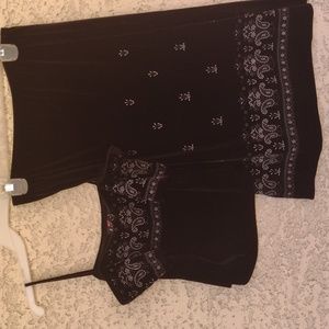 A two-piece sleeveless plush stretch material top and black skirt.